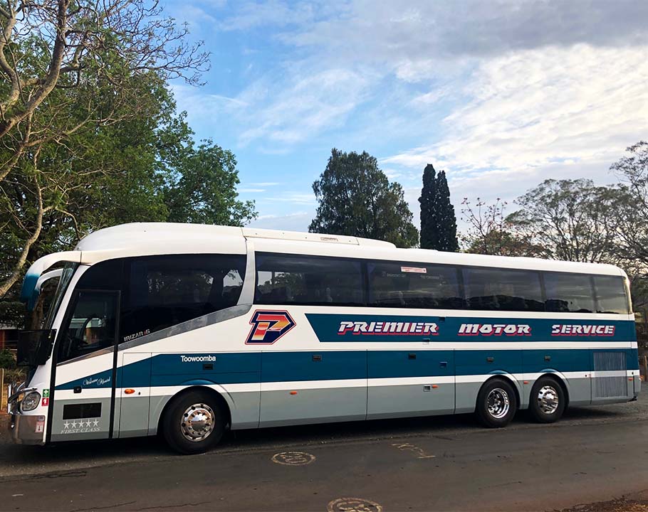Premier QLD coach parked in front of school